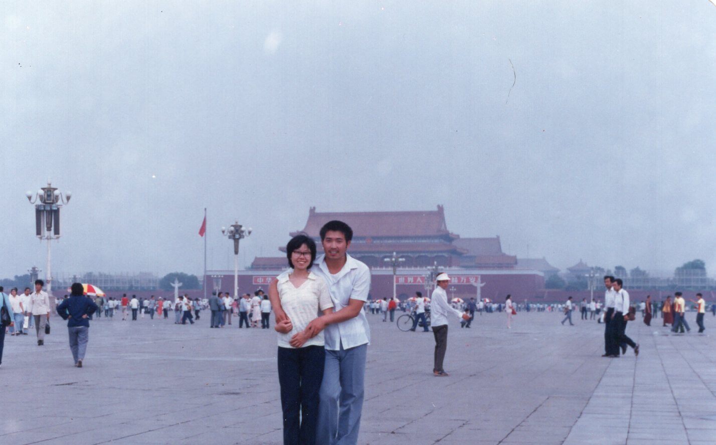 The writer's parents standing in Tiananmen Square in Beijing in the 80s.