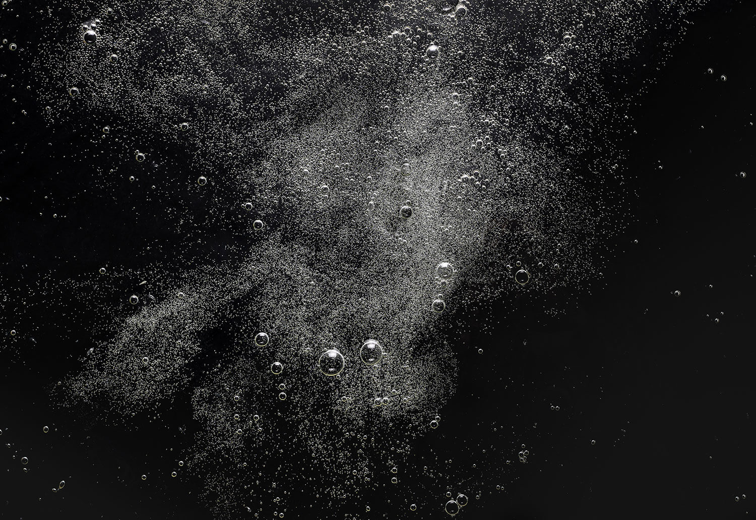 A black and white image of underwater bubbles.