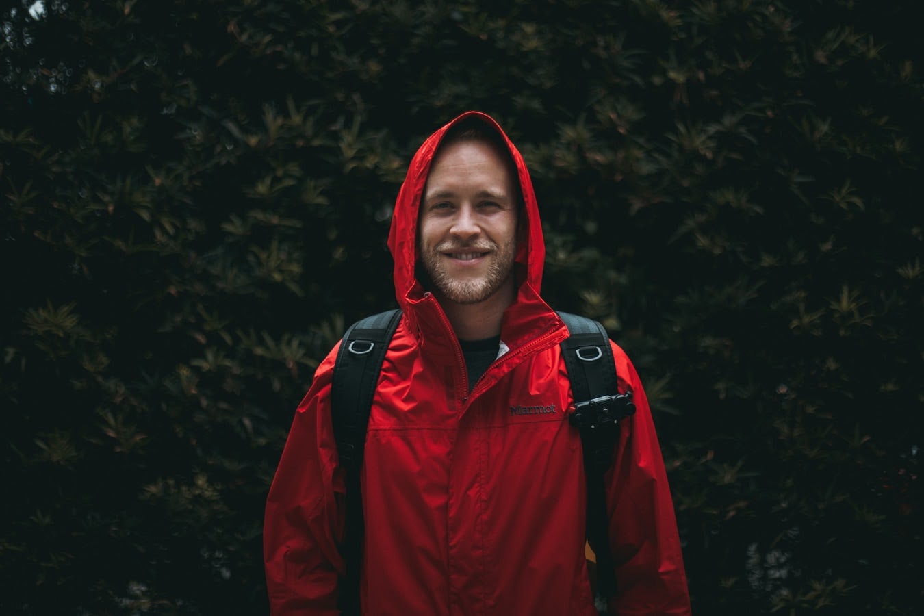 A man wearing a red rain jacket