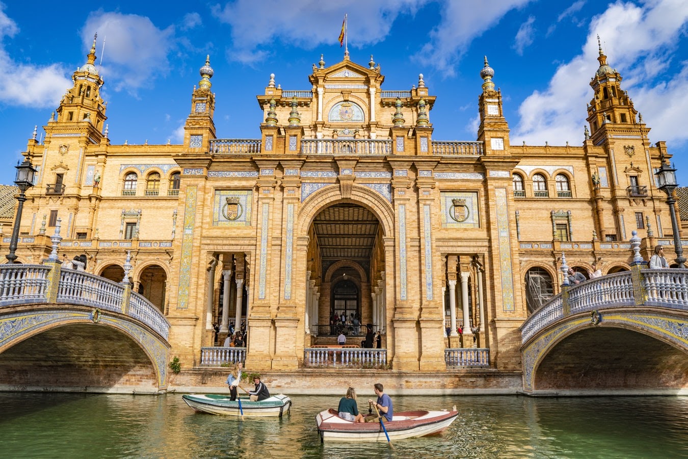 People enjoying a boat ride in Seville, Spain