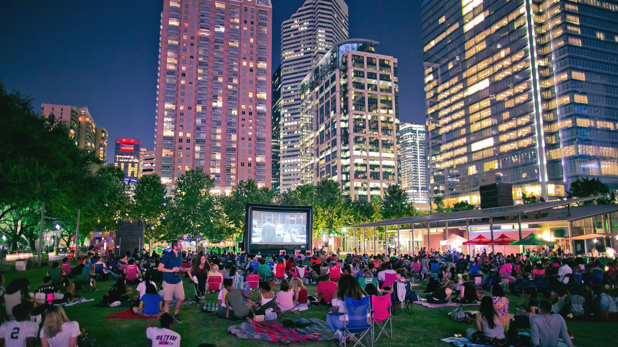 Crowd Watching A Projector Movie On The Lawn At Discovery Green In Houston, Texas
