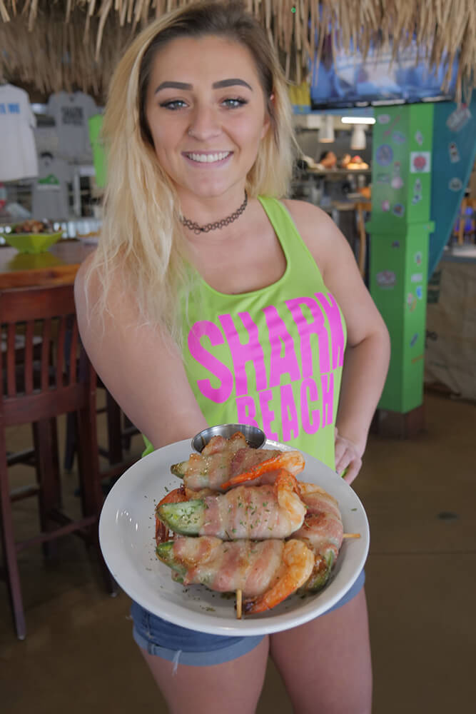 The minute you enter, you’re greeted by a friendly cabana girl who is ready to find you a seat at the bar or one of the many tables spread around, or at the restaurant’s centerpiece, a huge thatch-roofed seating area. (Photo: Marc Rains)