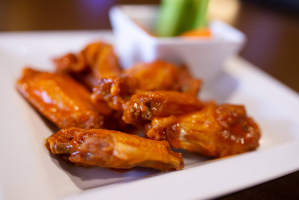 You can get wings coated in a choice of sauces from mild, medium, hot, or extra hot, along with teriyaki, barbecue, garlic parmesan, and more. (Photo: Sarah Eliza Roberts)