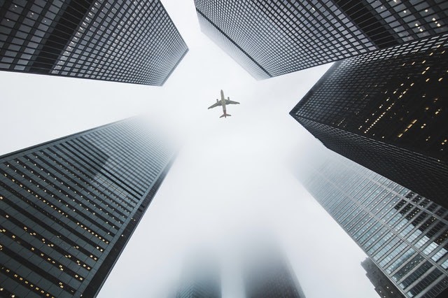 image of skyscrapers with airplane
