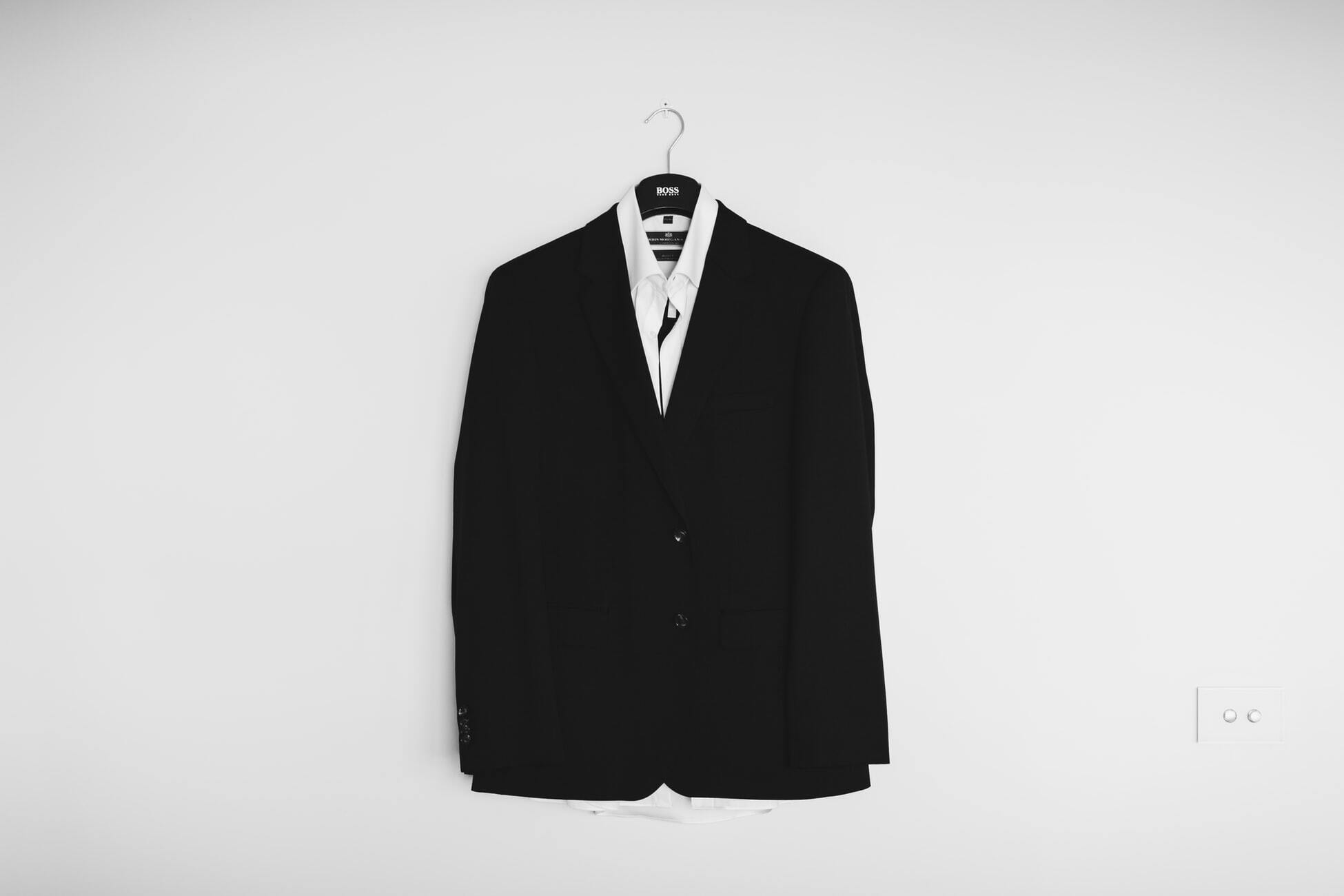 tailored suit hanging on wall