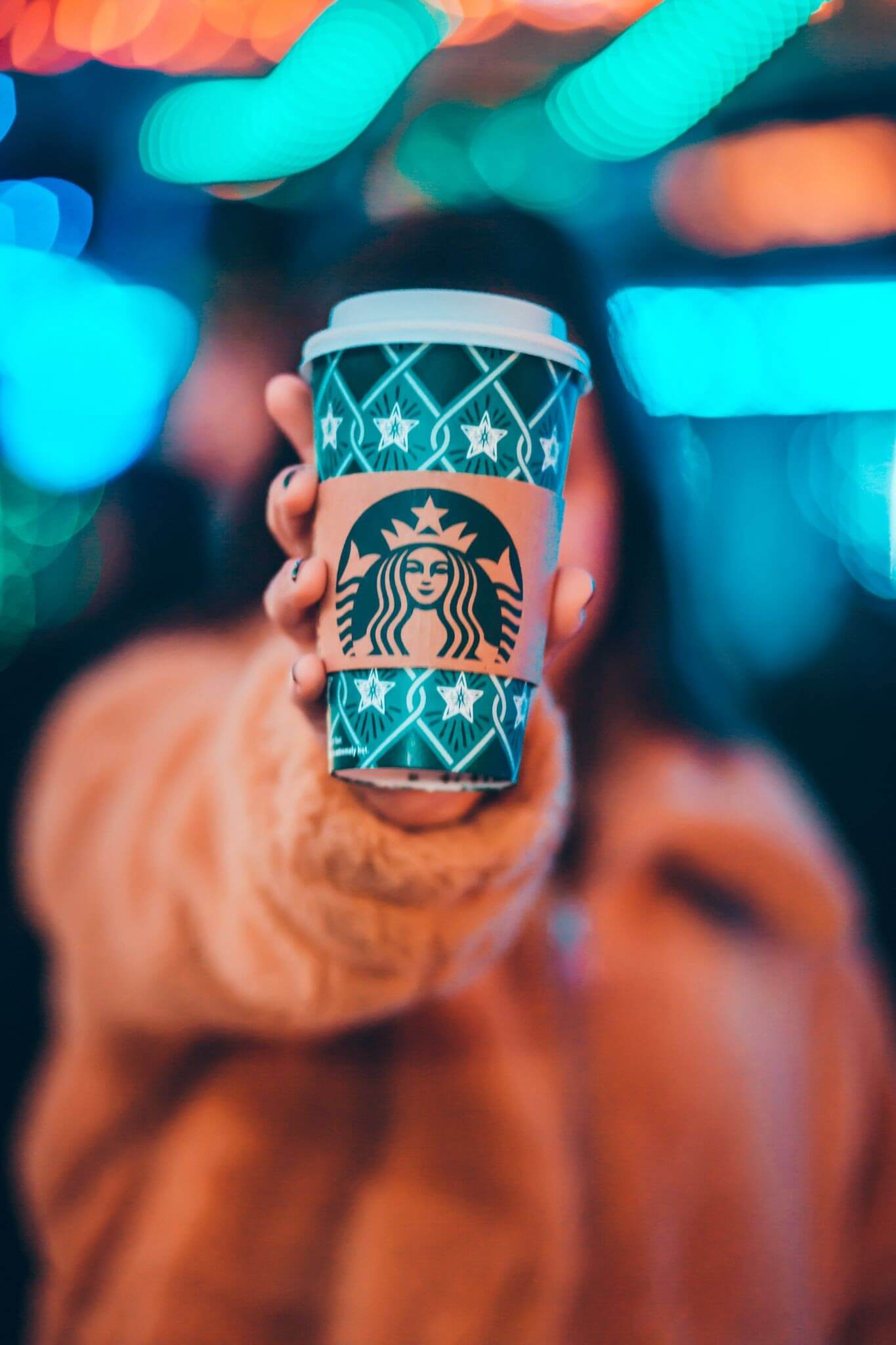 Starbucks brand ambassador holding a coffee