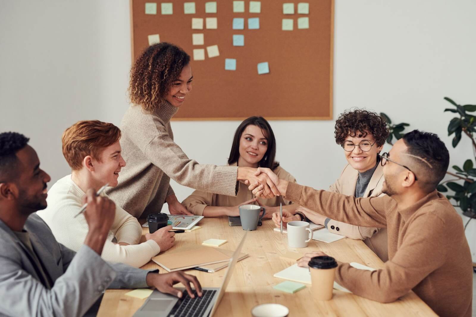 Two persons shaking hands during a business meeting