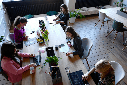 five women working in an office