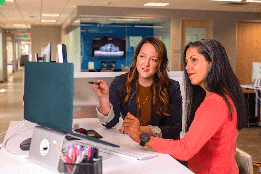 Two women looking at a laptop