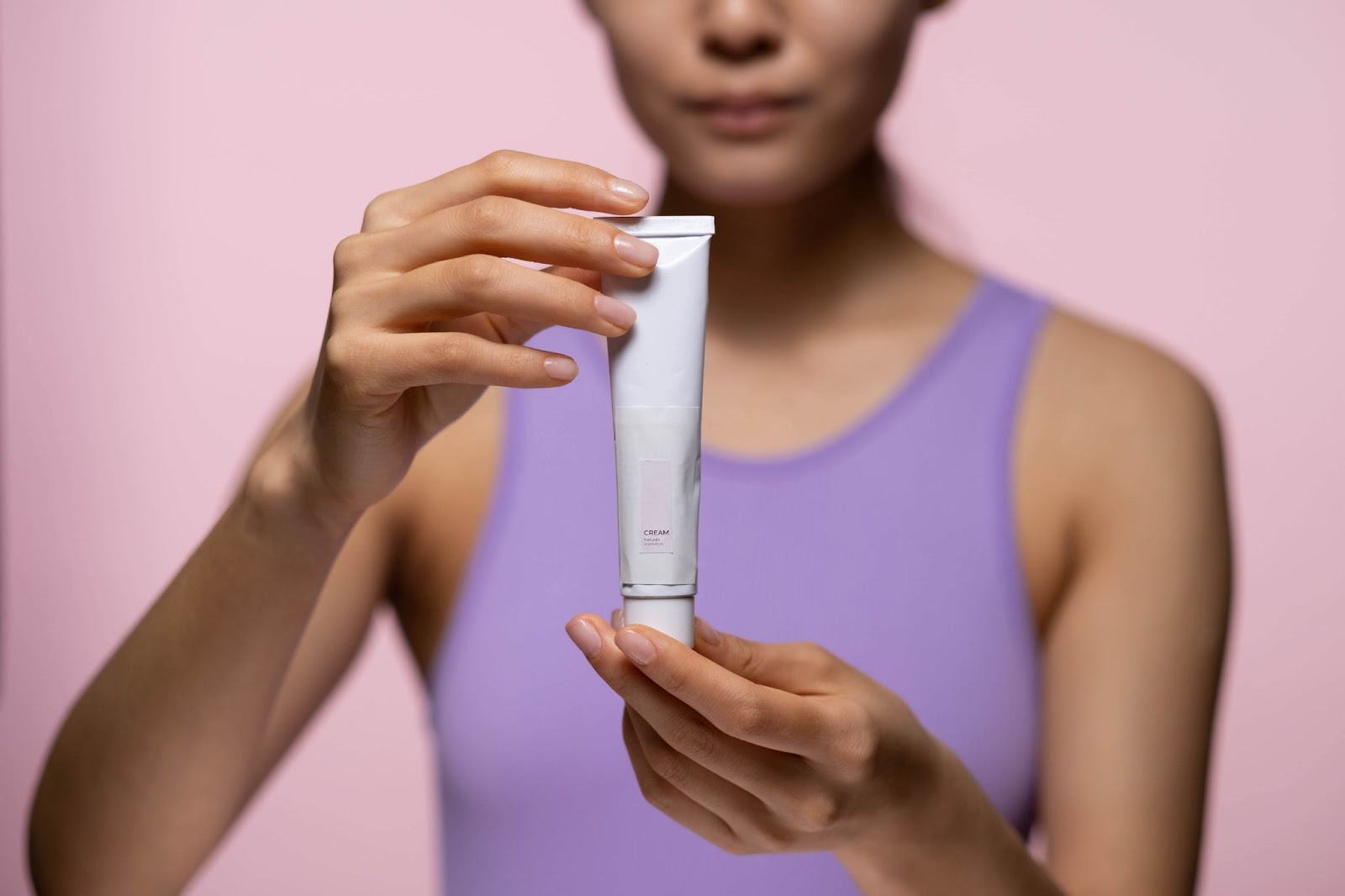 a woman holding a squeeze tube
