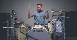 A man playing a drum kit.