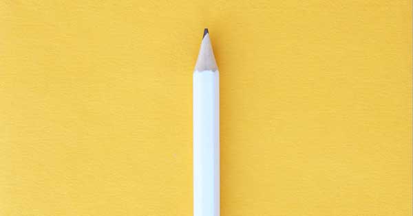 A white pencil with a yellow background.