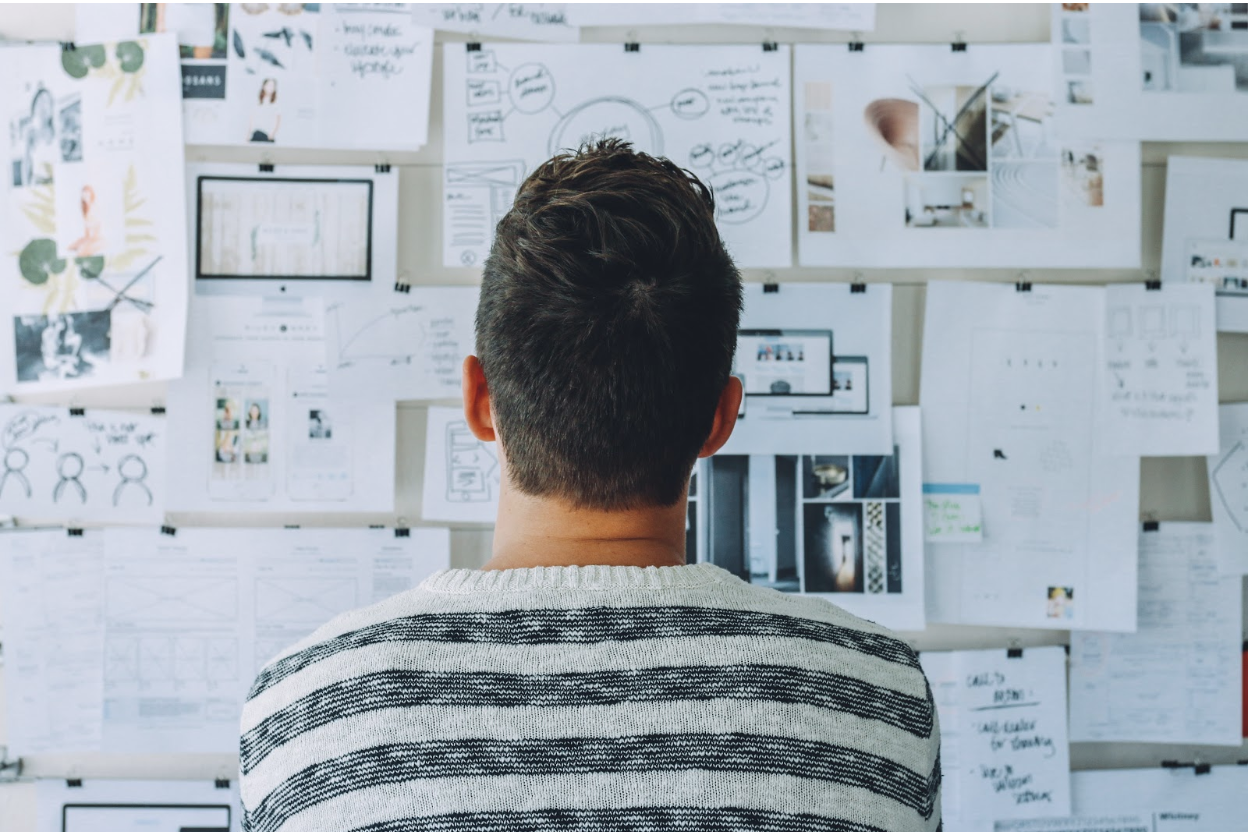 Man looking at UI design examples