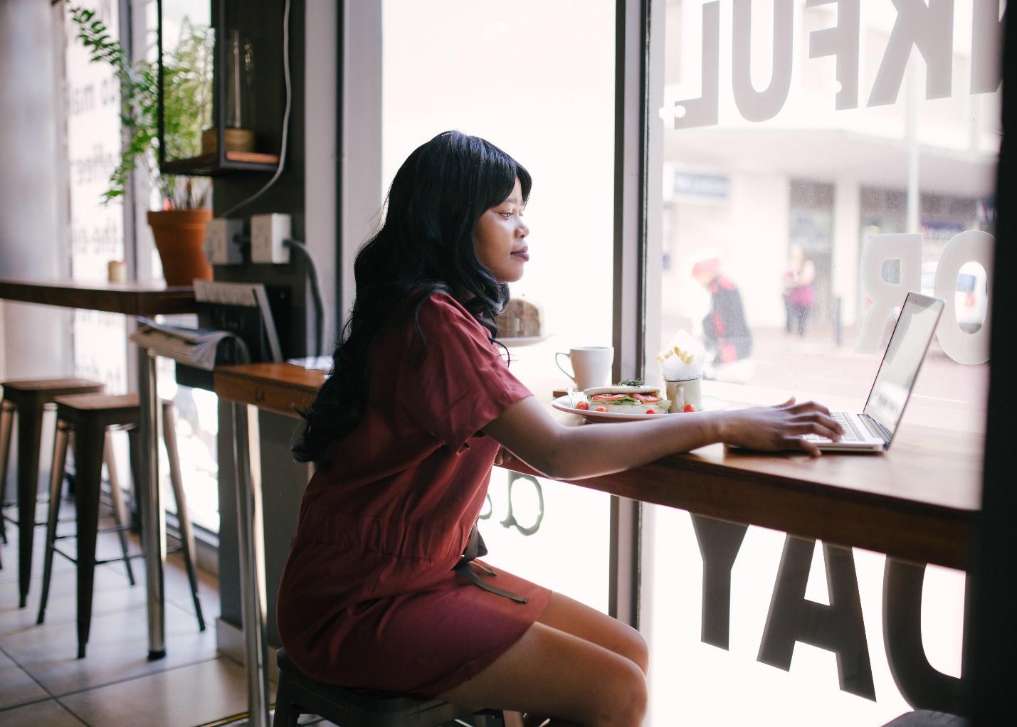 Female Remote Worker in a Coffee Shop
