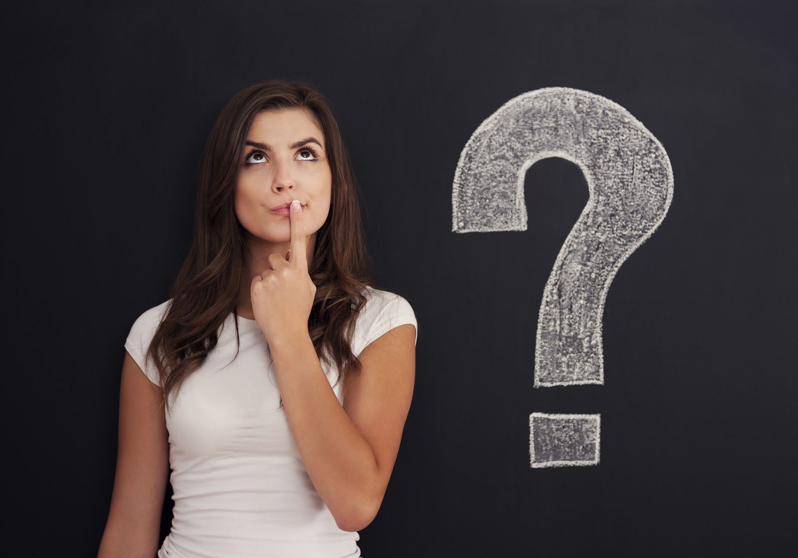 young woman engages with a question near a chalkboard
