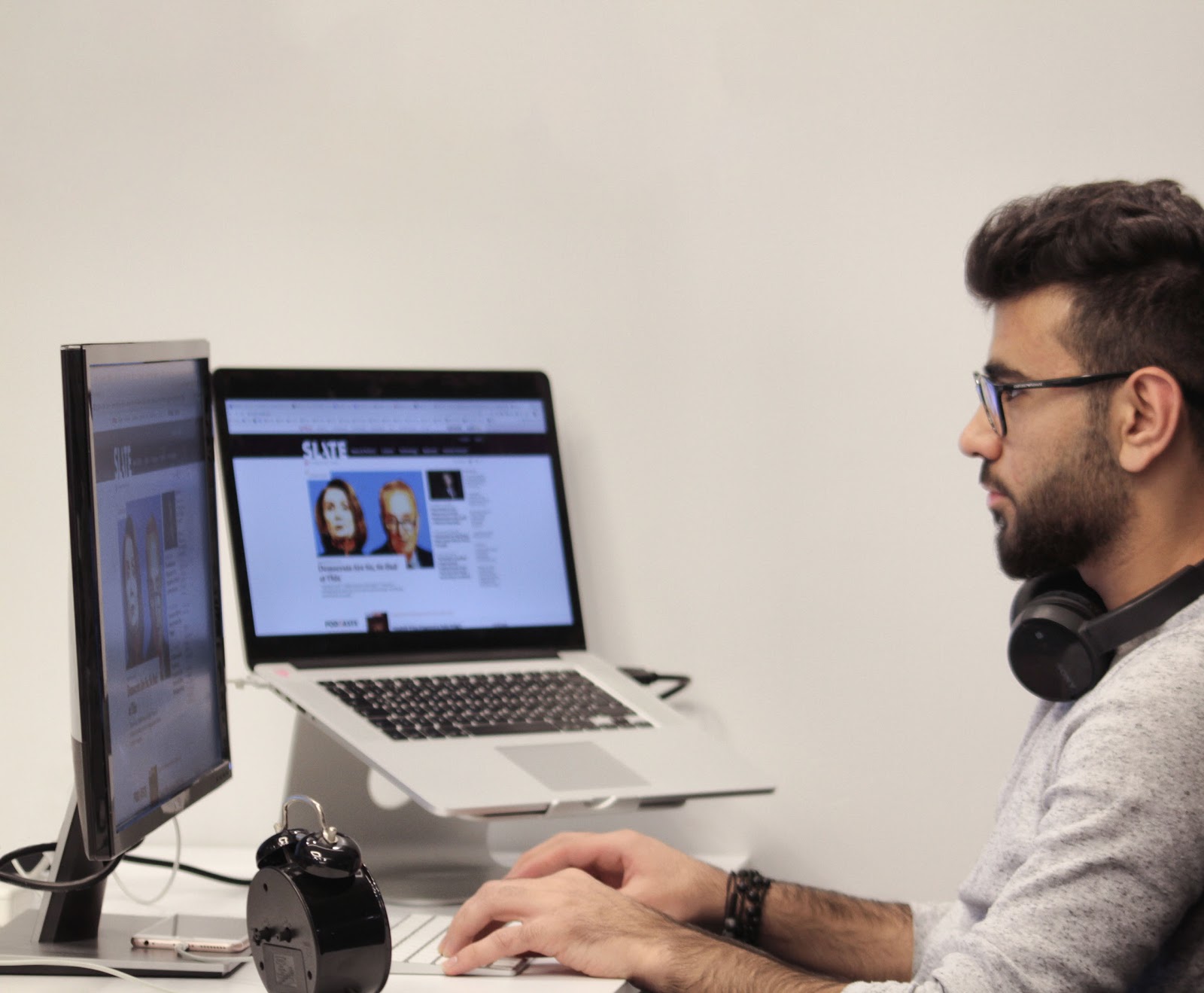 Man using a laptop and a monitor to work