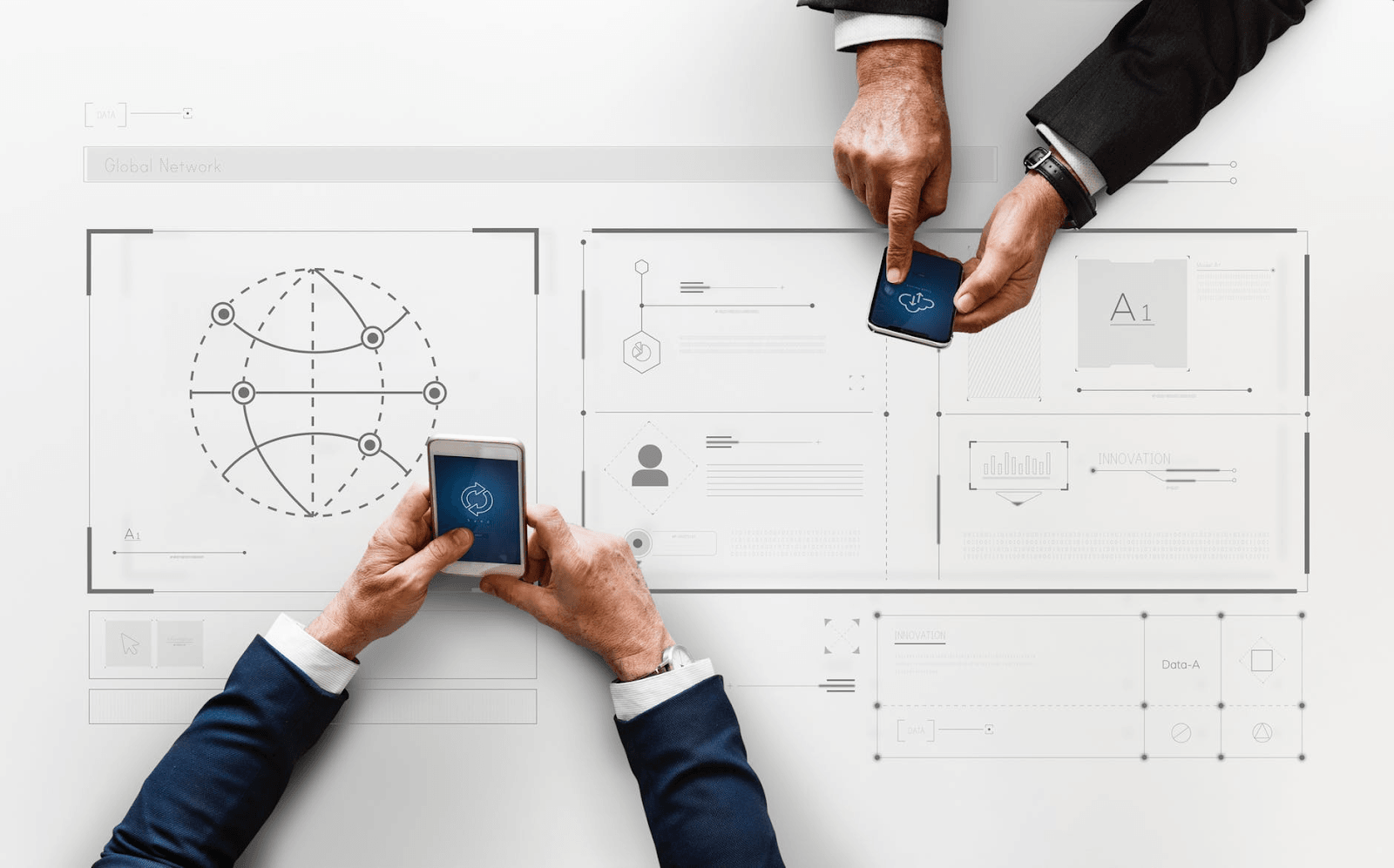 2 people on their phones over a white paper.