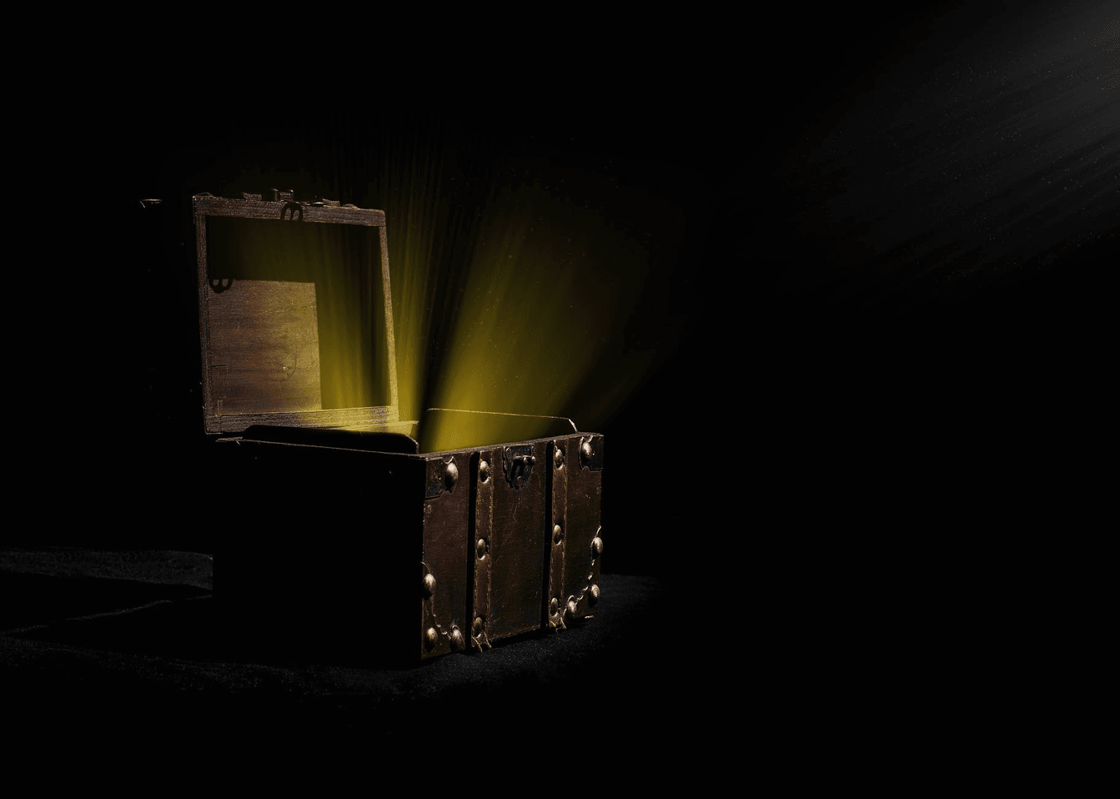 An open treasure chest with yellow light emerging from it.