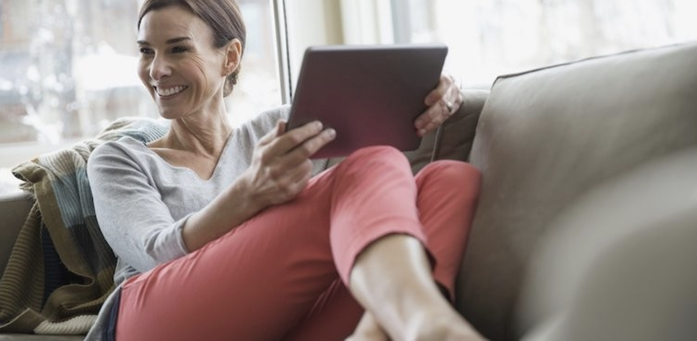 Woman holding tablet and smiling