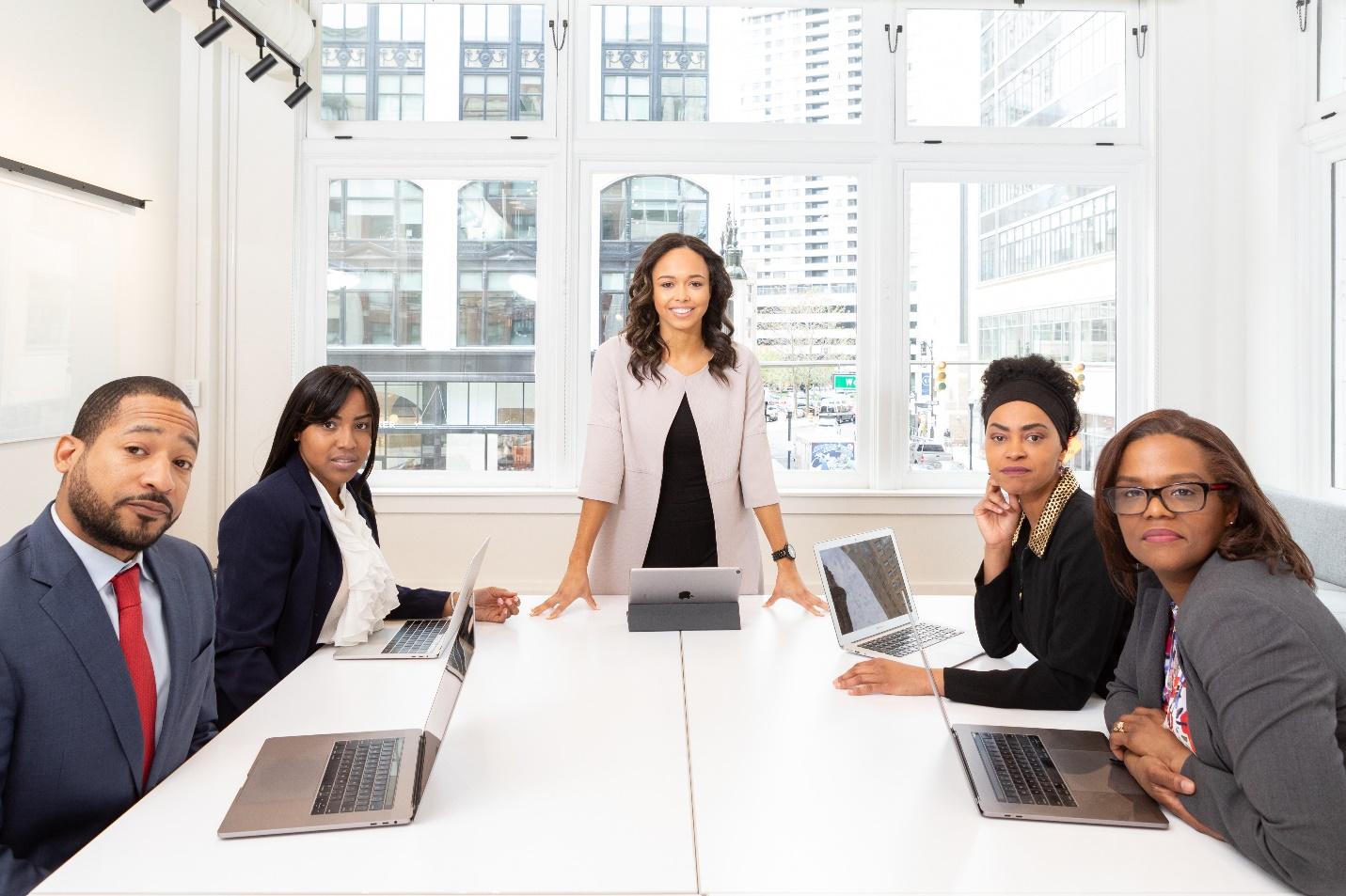 business meeting audience looks at viewer with mixed reactions