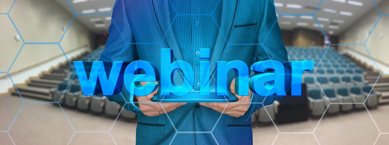 Man holding tablet with the word webinar hovering above it