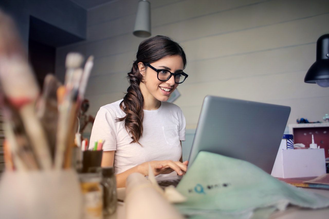 woman happily looking at computer