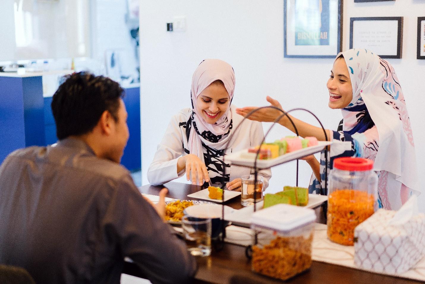 people laugh while eating and talking