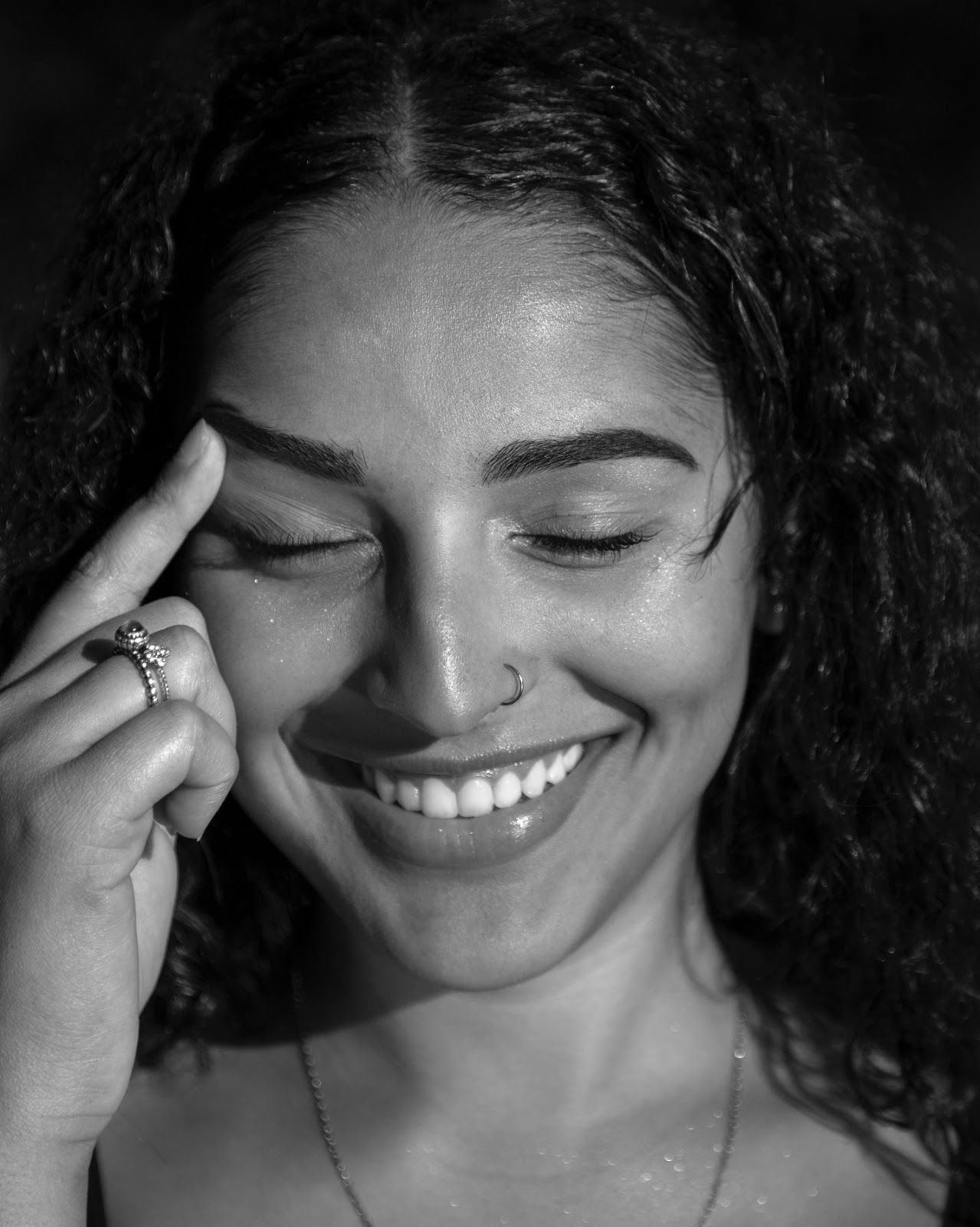 woman smiles and raises her eyebrow