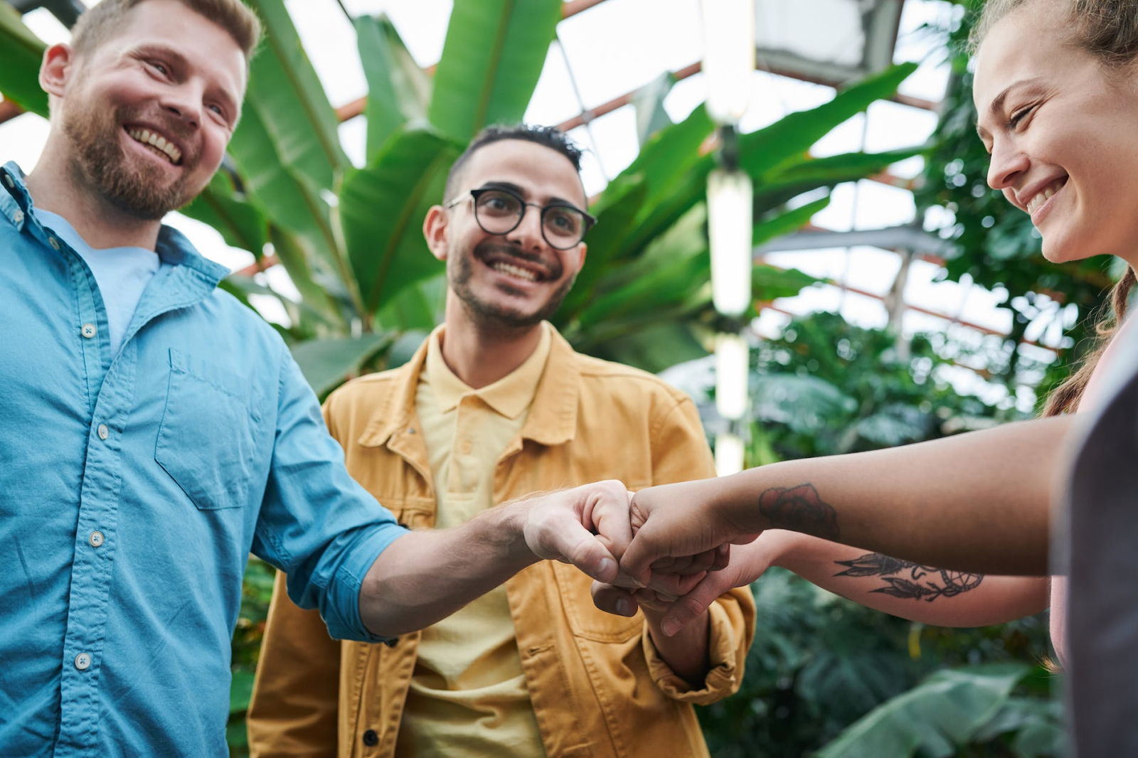 Four people putting their fists into a circle.