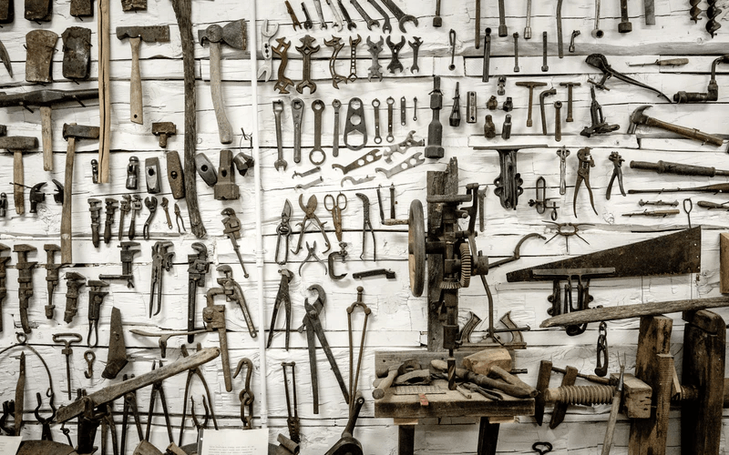 A wall filled with different kinds of tools.