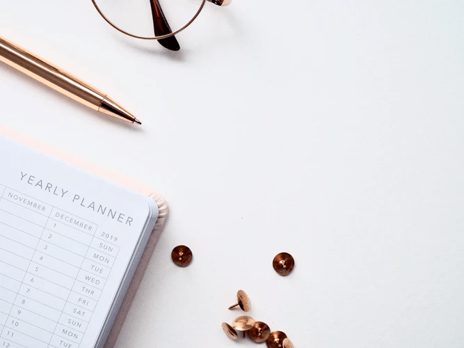 A yearly planner on a white table.