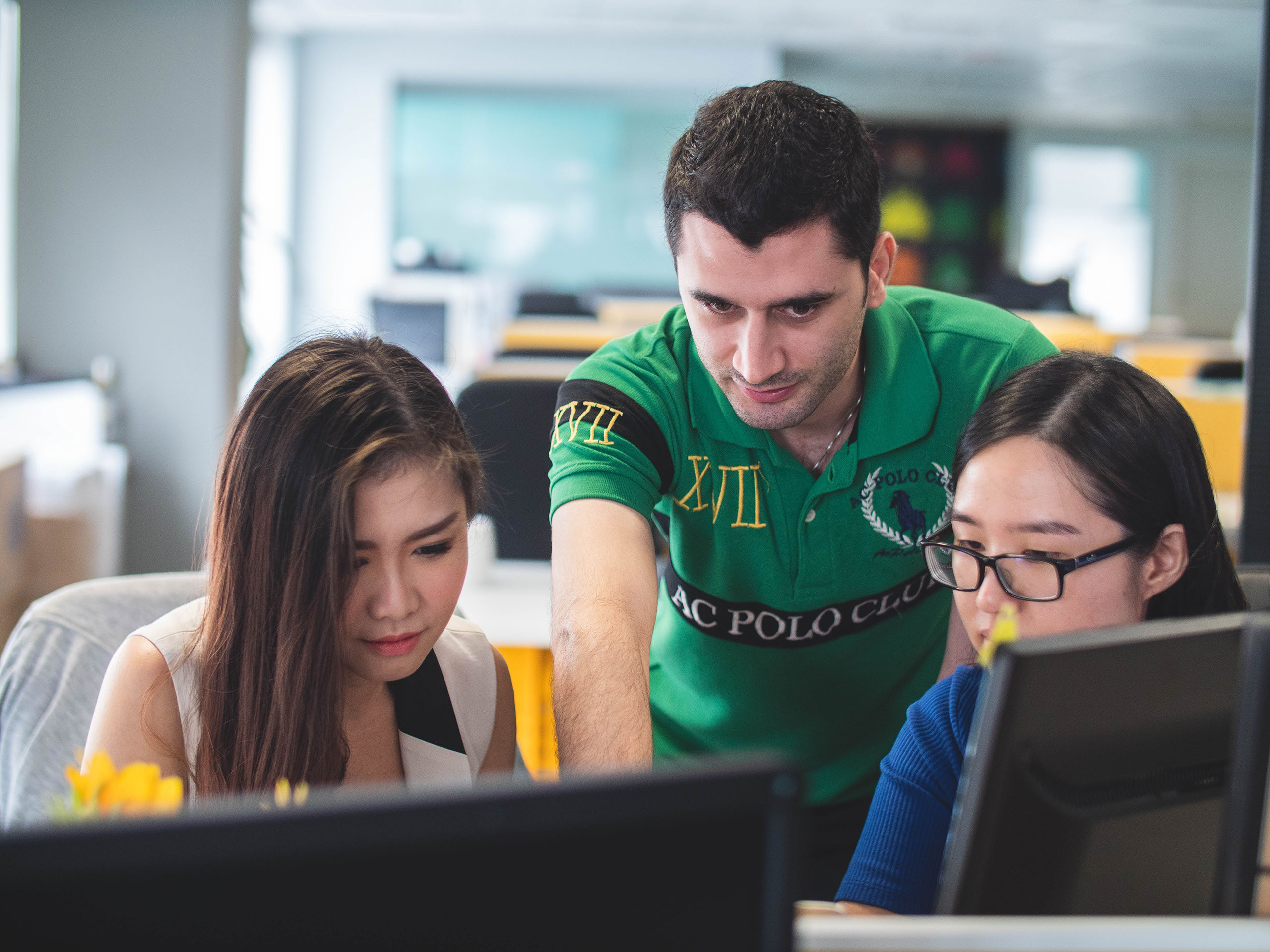 team collaborating in front of computer