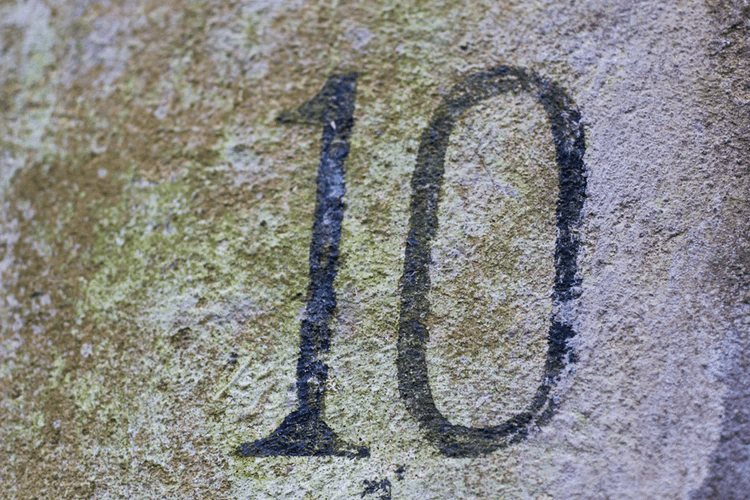 The number 10 written on concrete.