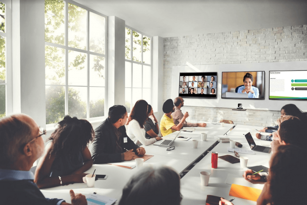 Professionals gathered in a conference room and talking with colleagues.