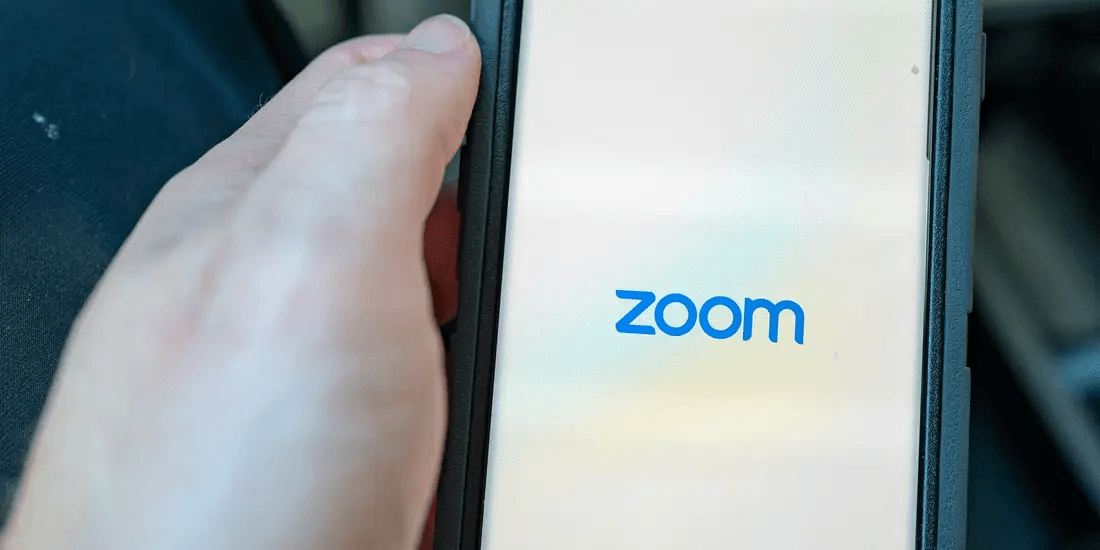 Person activating Zoom on their mobile phone.