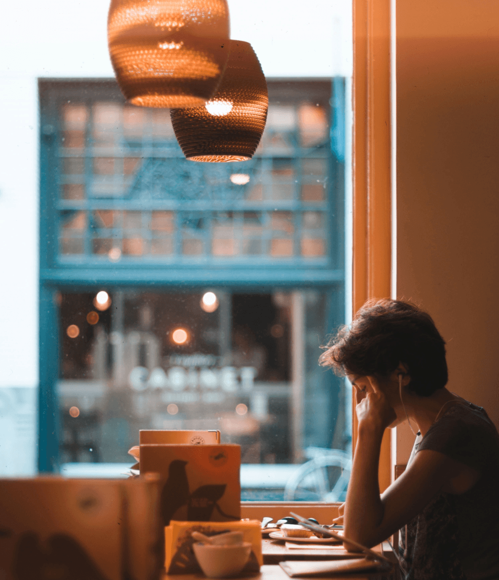 woman focusing on work in coffee shop