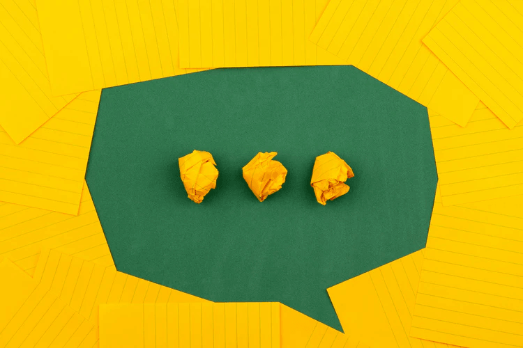A speech bubble made with yellow and green paper.