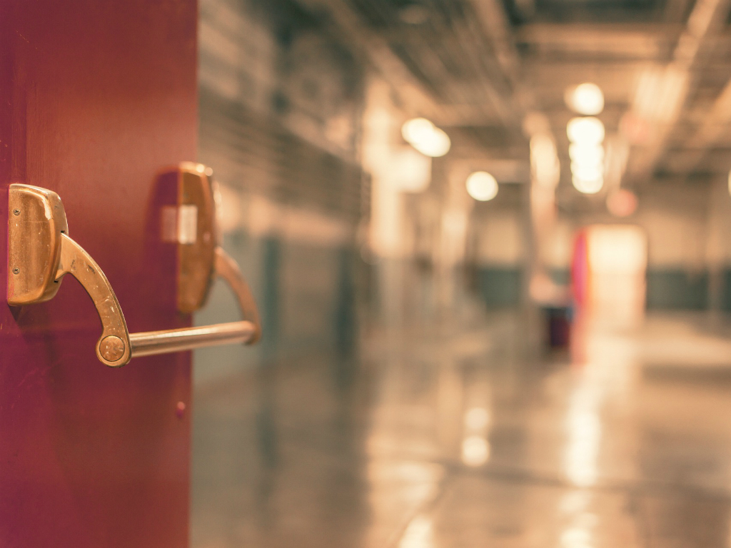 a red door opens to the hall of a columbus middle school