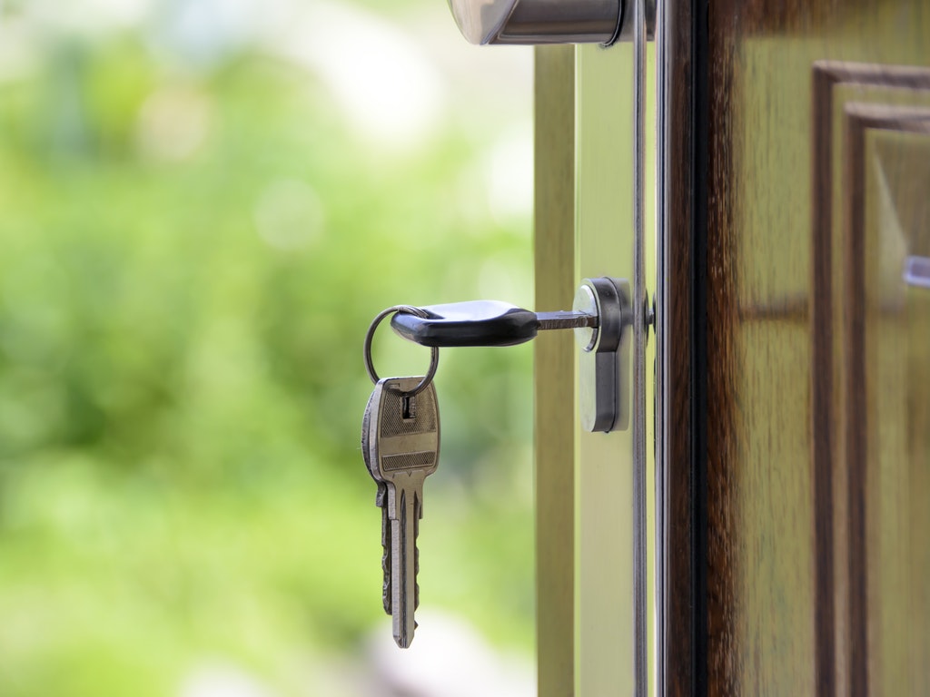 key in the door of a home 