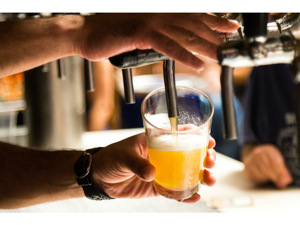 bartender pouring a beer on tap