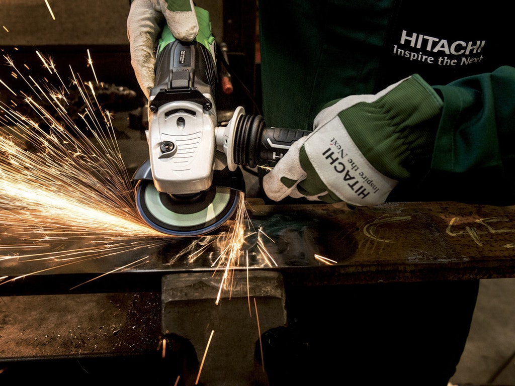 a person cutting with a saw as sparks fly