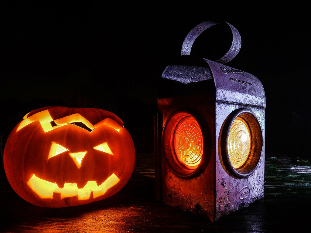 glowing jack-o-lantern next to a lantern