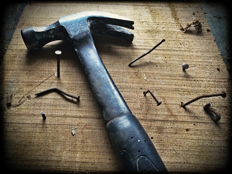 hammer and nails on wooden board