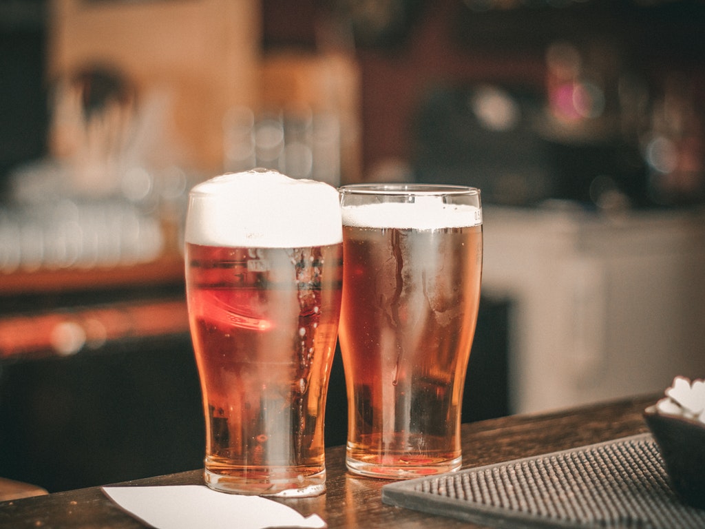 two beers on a brewery counter