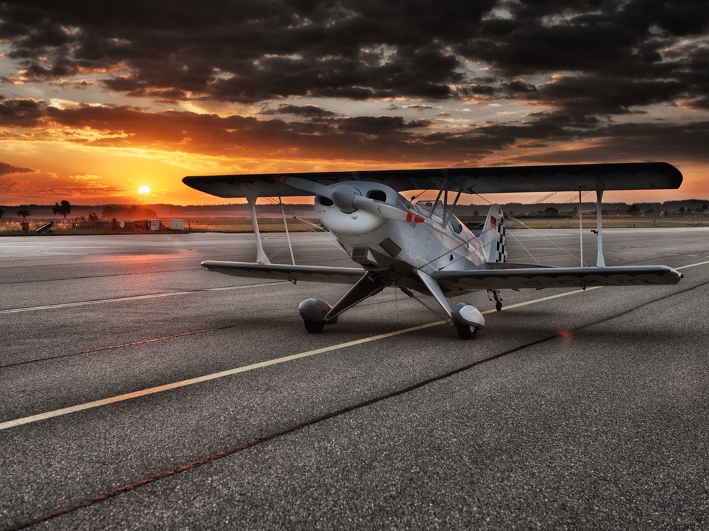 a plane taking off at sunset