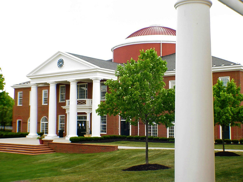 a red brick building with white columns in new albany, ohio