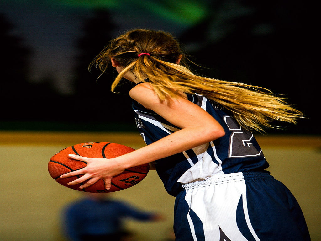 a female basketball player with long blonde hair