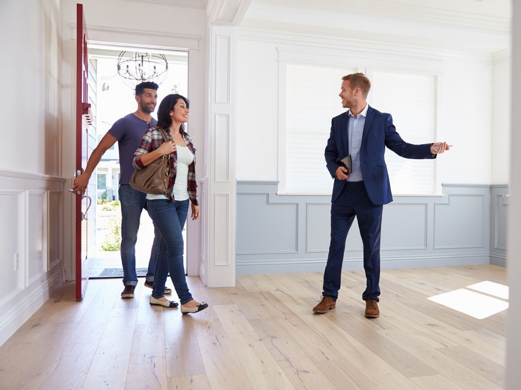 a realtor showing a couple a home