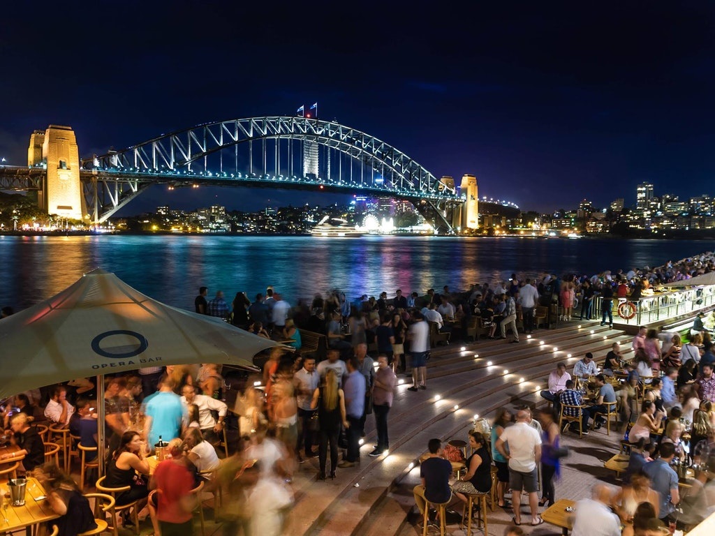 people enjoying dinner at a riverside restaurant