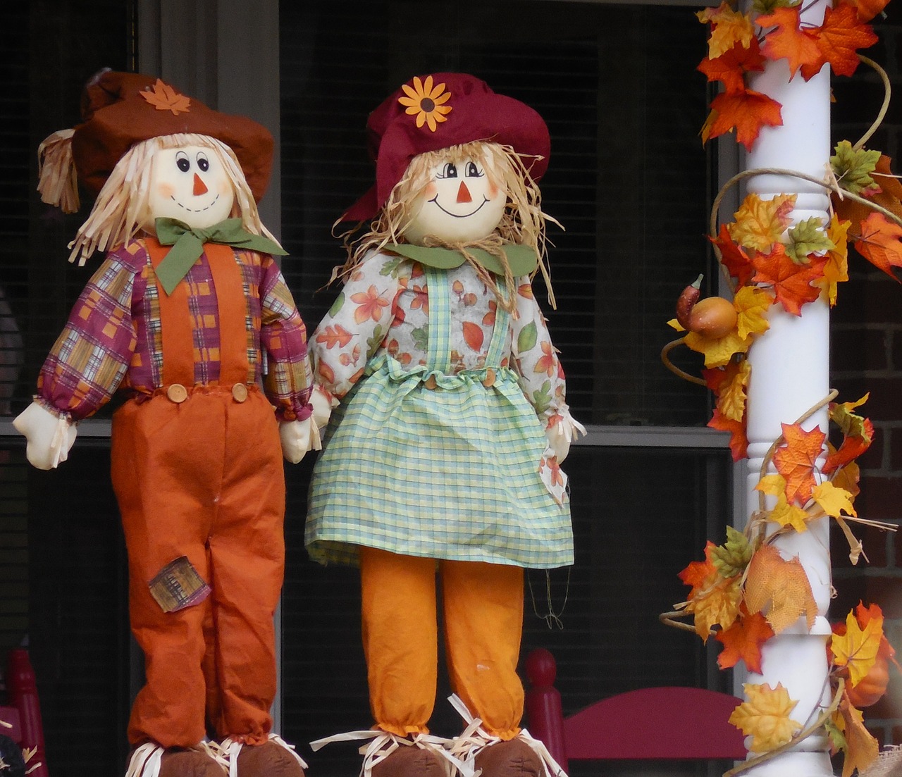 two small smiling scarecrows